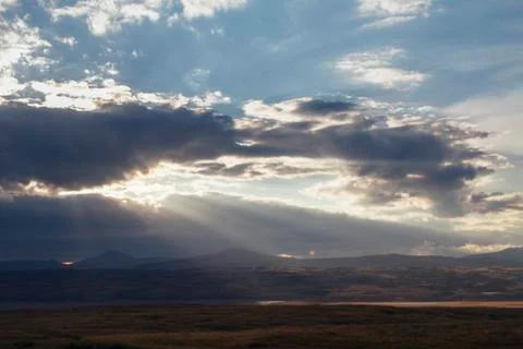 Sunset in the desert, the sun's rays Shine through the clouds. Ukok Plateau O Stock Photos