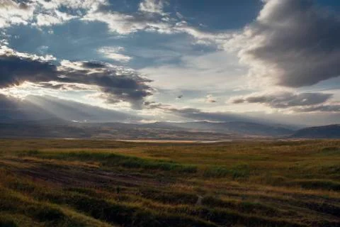 Sunset in the desert, the sun's rays Shine through the clouds. Ukok Plateau O Stock Photos