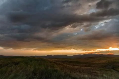 Sunset in the desert, the sun's rays Shine through the clouds. Ukok Plateau O Stock Photos