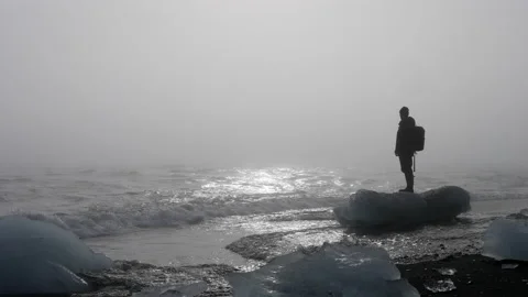 Sunset At Diamond Beach With Man On Top Of An Iceberg Fragment Stock Footage 233451933