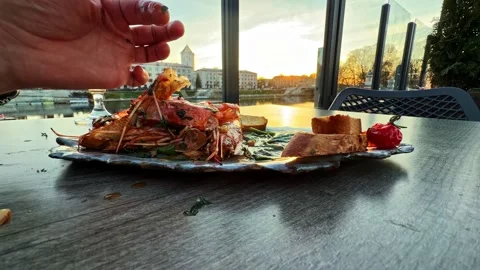 Sunset dining experience featuring assorted seafood platter 動画素材 336779264