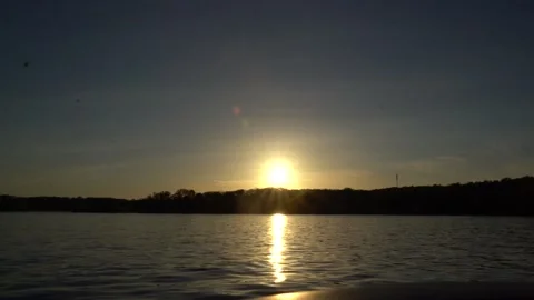 Sunset in the distance over a lake Vídeo Stock 194511017
