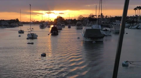 Sunset in the distance while motoring through moorings in Newport Harbor Cali Stock Footage 67490603