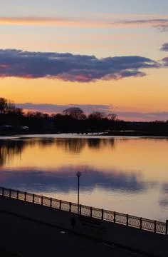 Sunset on Dnieper river. Beautiful dramatic cloudy sky and tree silhouettes Stock Photos