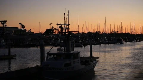 Sunset at Dock while man is unloading boat Stock Footage 86298637