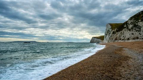 Sunset at Dorset bridge with white cliffs in the background Stock Photos
