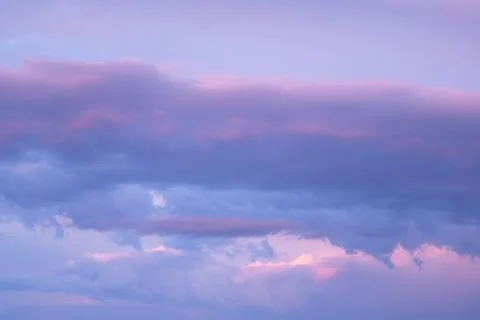 Sunset dramatic with beautiful layer of pastel violet clouds sky background Stock Photos