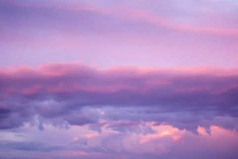 Sunset dramatic with beautiful layer of pastel violet clouds sky background Stock Photos