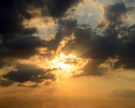 Sunset in a dramatic cloud filled sky Stock Photos