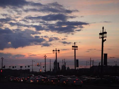 Sunset in dramatic clouds over asphalt road Stock Photos