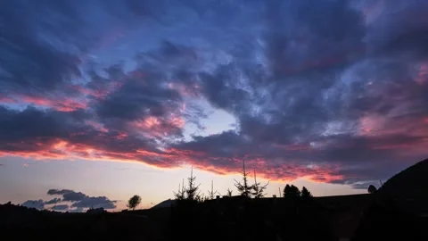 Sunset with dramatic clouds over a serene landscape, perfect for tranquility Video stock 284915838