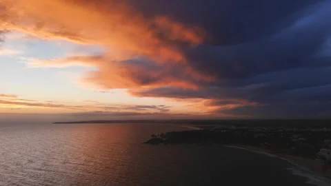 Sunset with dramatic clouds showing contrast of deep blue and fiery orange hues Stock Footage 301013303