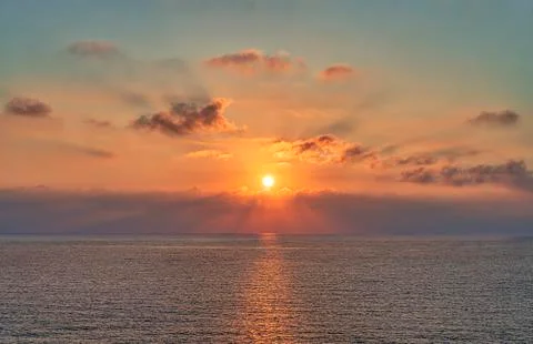 Sunset with dramatic cloudscape over the sea Stock Photos