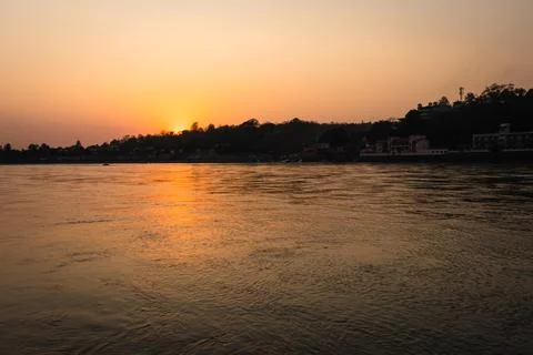 Sunset dramatic orange sky over river horizon at evening from flat angle Фото