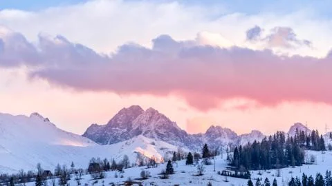 Sunset with dramatic sky and mountain peaks illuminated by sunlight in Tatra Stock Photos