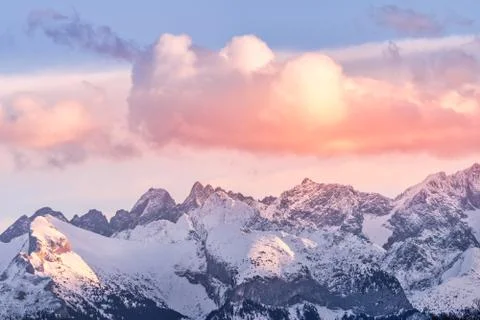 Sunset with dramatic sky and mountain peaks illuminated by sunlight in Tatra Stock Photos