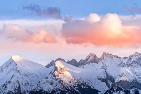 Sunset with dramatic sky and mountain peaks illuminated by sunlight in Tatra Stock Photos
