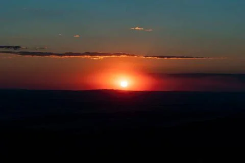 Sunset, dramatic sky and scenic landscape. Landscape with sun, glowing sky... Stock Photos