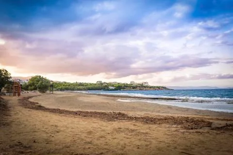 Sunset with dramatic sky over the beach at Rafina, Greece Stock Photos