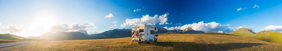 Sunset dramatic sky over camper van in Campo Imperatore highlands, Abruzzo, I Stock Photos