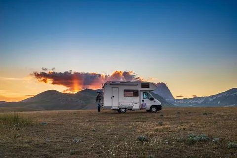 Sunset dramatic sky over camper van in Campo Imperatore highlands, Abruzzo, I Stock Photos