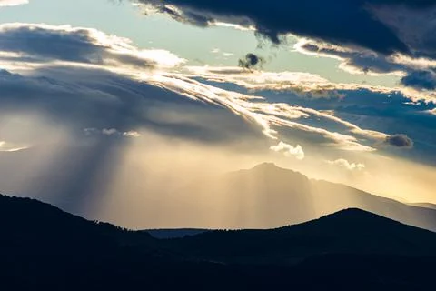 Sunset dramatic sky over epic mountain range silhouette, Marche, Italy. Sunbe Stock Photos