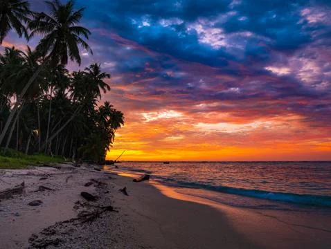 Sunset dramatic sky on sea, tropical desert beach, no people, stormy clouds,  Stock Photos