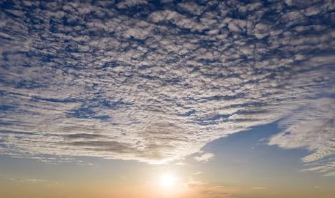 Sunset in dramatic sky. Sunset sunlight on clouds. Sunset radiant golden. Sun Stock Photos
