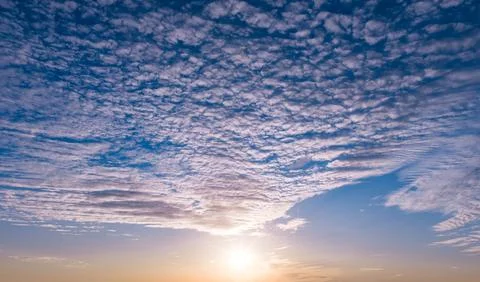 Sunset in dramatic sky. Sunset sunlight on clouds. Sunset radiant golden. S.. Stock Photos