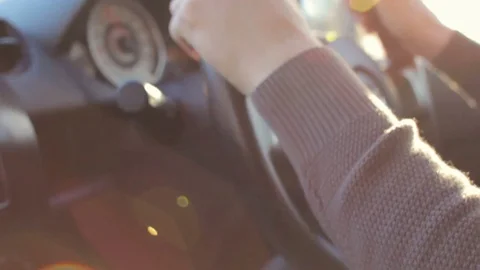 Sunset drive. Young man is driving a car under the sun. Lens flare, soft light Stock Footage 74433965