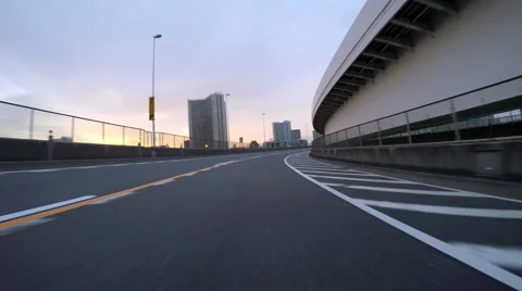 Sunset driver POV climbing the Rainbow Bridge ramp from central Tokyo. Stock Footage 61865604