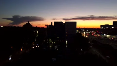 Sunset Drone Ascending Over NYC Skyline &amp; Busy Queens Blvd. Traffic 4K Aerial Stock Footage 165311396