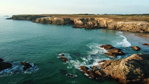 At sunset, the drone flies over isolated rocks on the seaside in France Stock Footage 164747034
