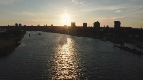 Sunset drone flight over the River Elbe, Hamburg towards the west with Stock Footage 133494419