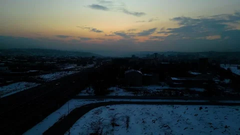 At sunset, a drone flying with crows over the road 動画素材 294800818