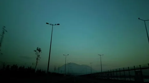 At sunset, a drone flying with crows over the road 動画素材 294815546