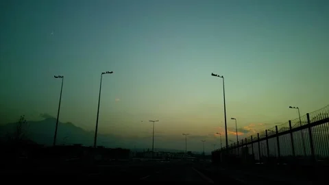 At sunset, a drone flying with crows over the road 動画素材 294816977