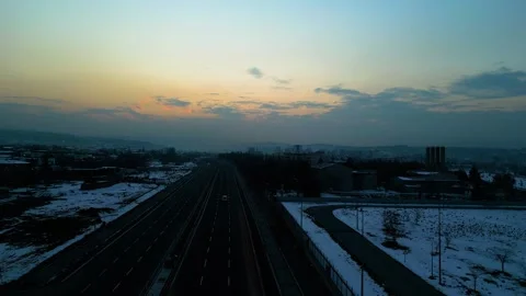 At sunset, a drone flying with crows over the road 動画素材 294817882