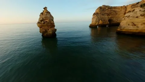Sunset drone footage of dramatic coastal cliffs overlooking tranquil sea Video stock 346091751