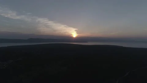 Sunset drone footage - hovering above the forest with a view of the sea Stock Footage 148404661