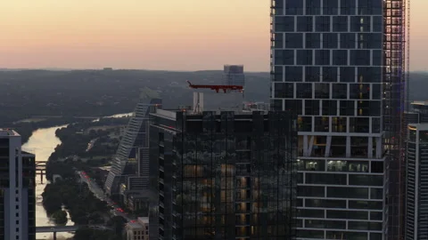Sunset Drone Orbit Over Downtown Austin Skyscrapers, River, and Bridge Video stock 322609938