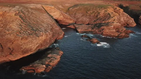 At sunset, the drone rotates around a rocky seaside in France Stock Footage 164584099