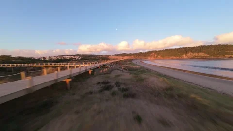 Sunset drone shot of coastal boardwalk Stock Footage 344577448