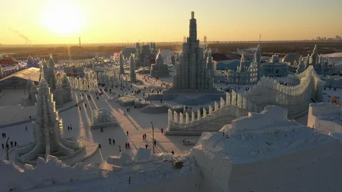 Sunset drone shot crowds visiting popular ice sculptures festival Harbin China Stock Footage