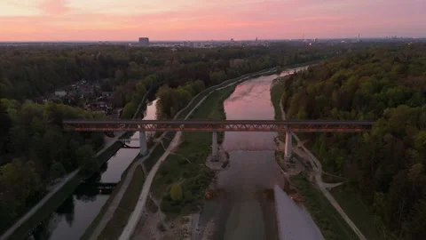 Sunset drone shot over Isar Valley, showing Grosshesselohe Bridge, Isar canal Stock Footage 316656970