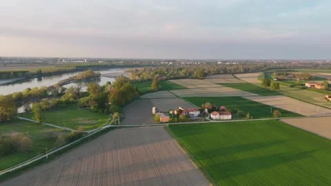 Sunset drone shot over Po River bend and patchwork fields at Olza di Stock Footage 308443306