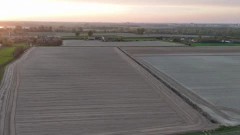 Sunset drone shot over pre-seeded furrows near Olza di Castelvetro Piacentino Stock Footage 308443711