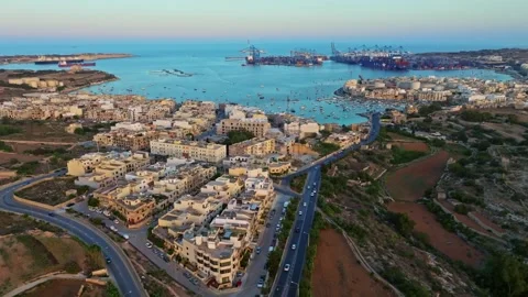 Sunset drone view of Birzebbuga city. Port, boats, marina. Maltese island Stock Footage 278886958