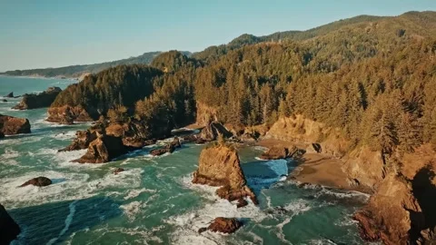 Sunset Drone View of Ocean, Rocks, and Mountains – Waves Crashing Toward Shore Stock Footage 315098831