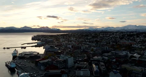 Sunset drone view over Tromso city Norway harbor with Hurtigruten ship docking Vídeo Stock 323369116